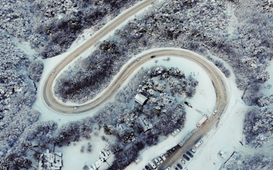 Aerial view of winding road through snowy forest on Ushuaia Martial Glacier Tour.