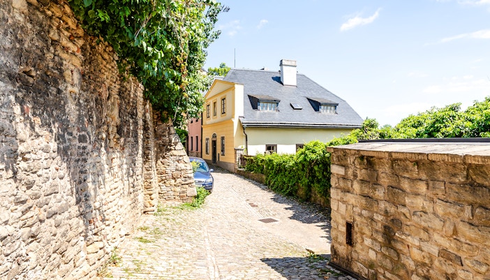 Historic buildings on cobblestone Ruthardska Street in Kutna Hora, Czech Republic.