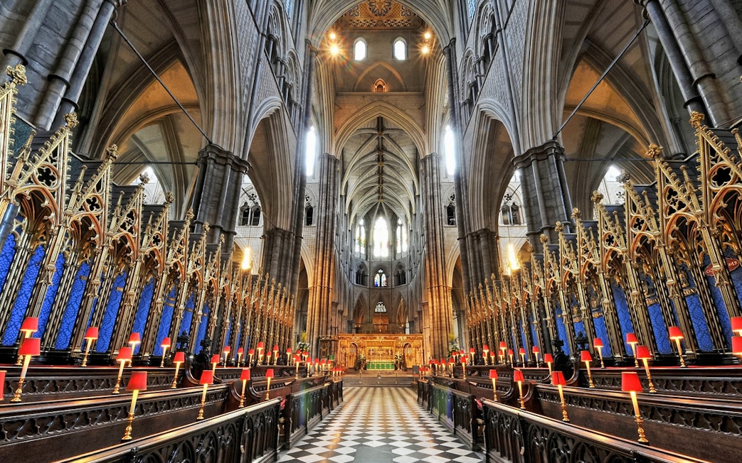Westminster Abbey interior with ornate arches and choir stalls, London.