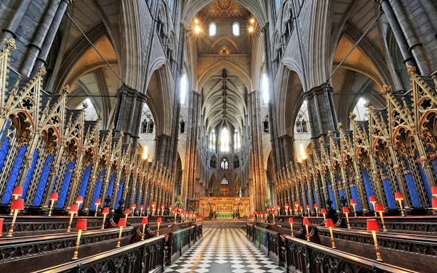Westminster Abbey interior with ornate arches and choir stalls, London.