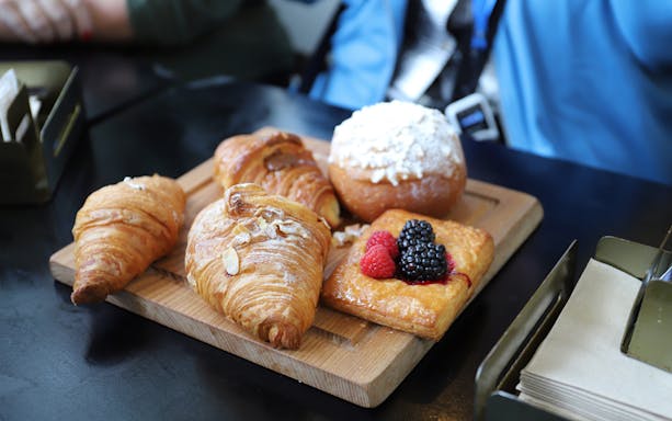 Assorted pastries on a wooden board during a Rome morning food tour.