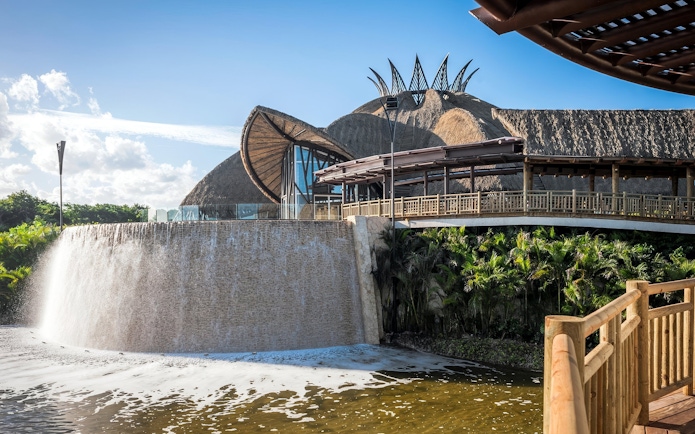 Vidanta Theater in Riviera Maya with waterfall and lush surroundings.
