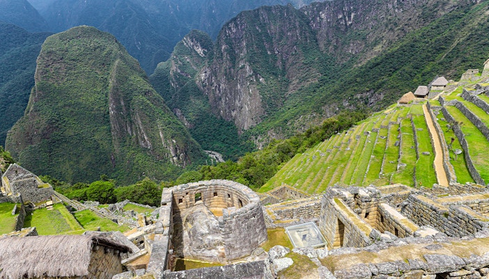Sun Temple view point overlooking terraces and mountains at Machu Picchu, Peru.