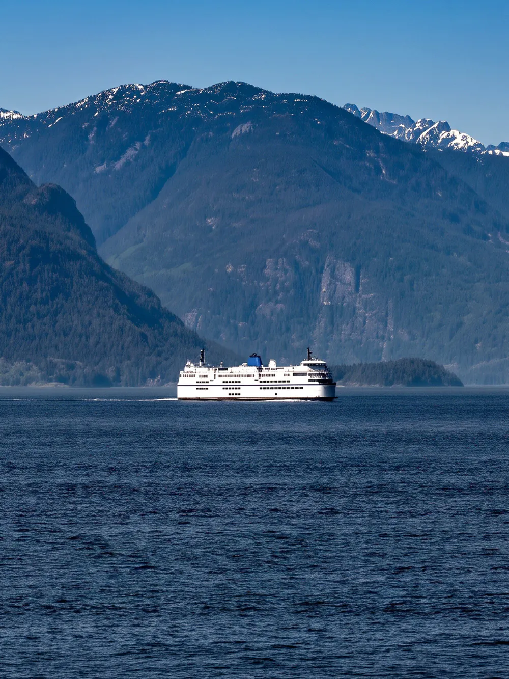 Ferry crossing ocean with mountains in background, route from Vancouver to Nanaimo, Canada.