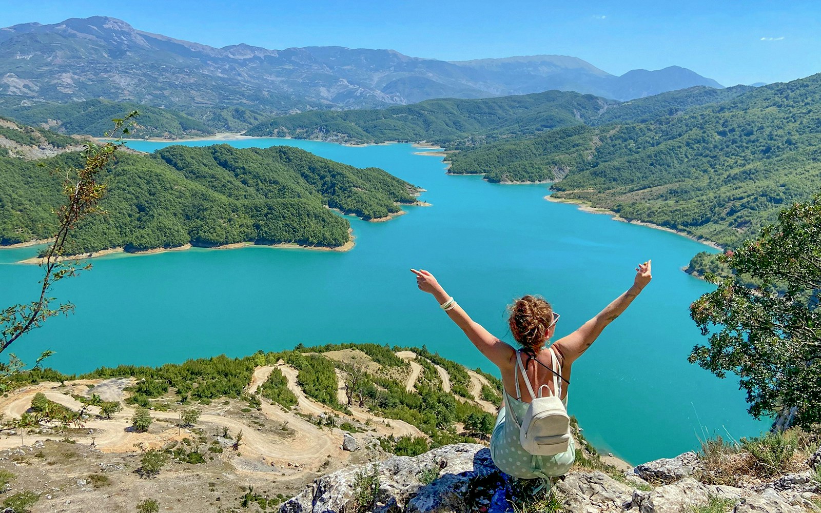 Guests overlooking Bovilla Lake surrounded by lush green hills.