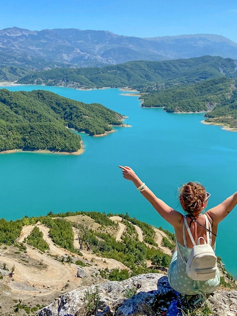 Guests overlooking Bovilla Lake surrounded by lush green hills.