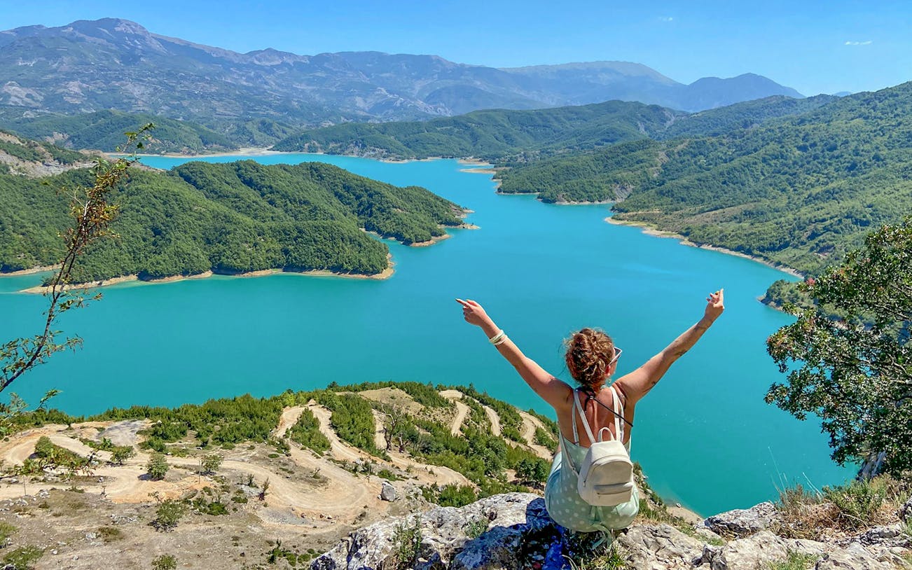 Guests overlooking Bovilla Lake surrounded by lush green hills.