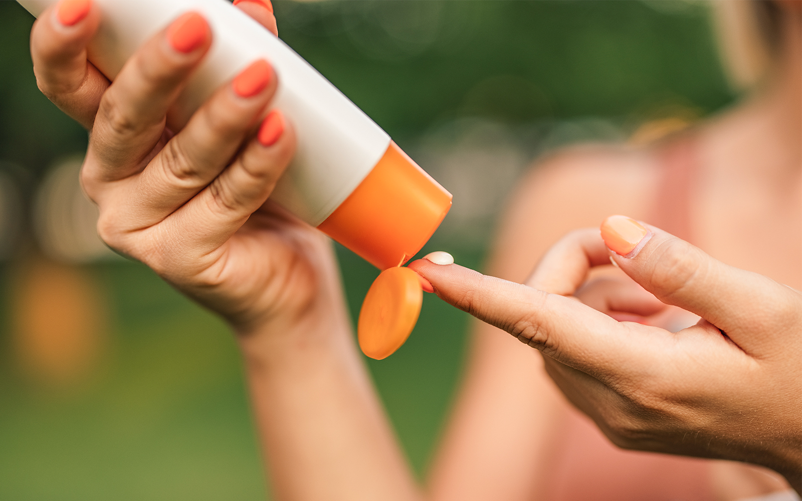 Applying sunscreen outdoors.