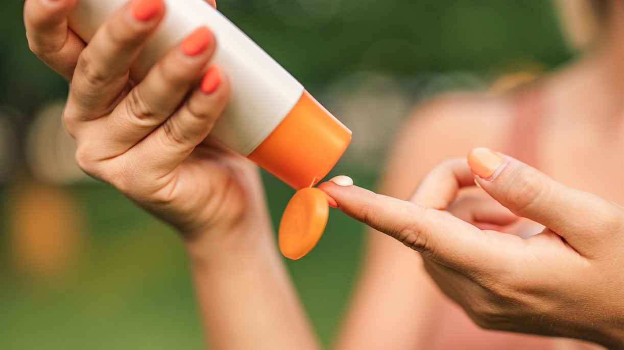 Applying sunscreen outdoors.