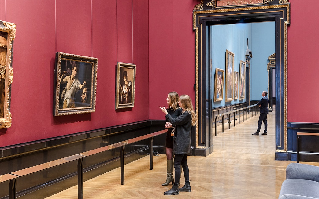Visitors exploring paintings at Kunsthistorisches Museum, Vienna.