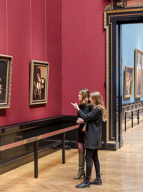 Visitors exploring paintings at Kunsthistorisches Museum, Vienna.