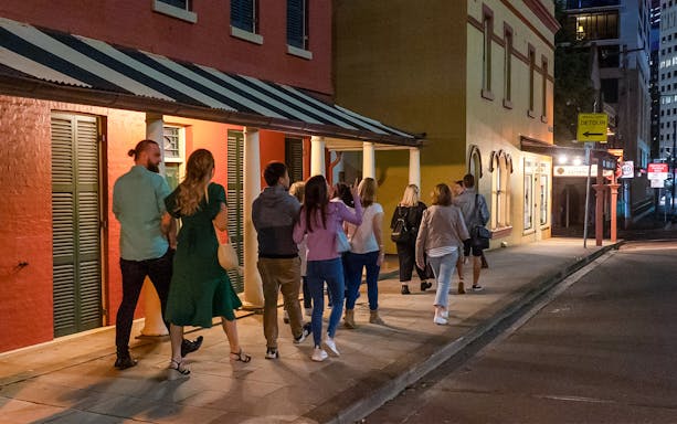 Group walking on a Sydney street during a True Crime Stories Guided Tour.