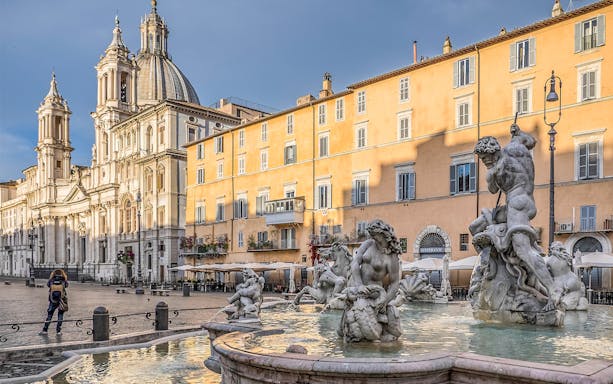 Piazza Navona with Fountain of Neptune in Rome during guided tour.
