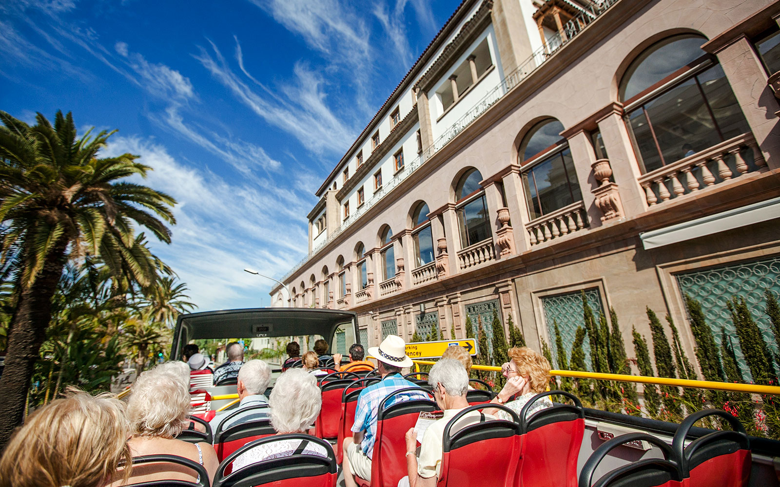 Open-top bus tour passing Hotel Mencey in Santa Cruz.