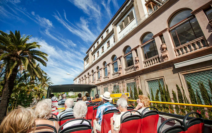 Open-top bus tour passing Hotel Mencey in Santa Cruz.
