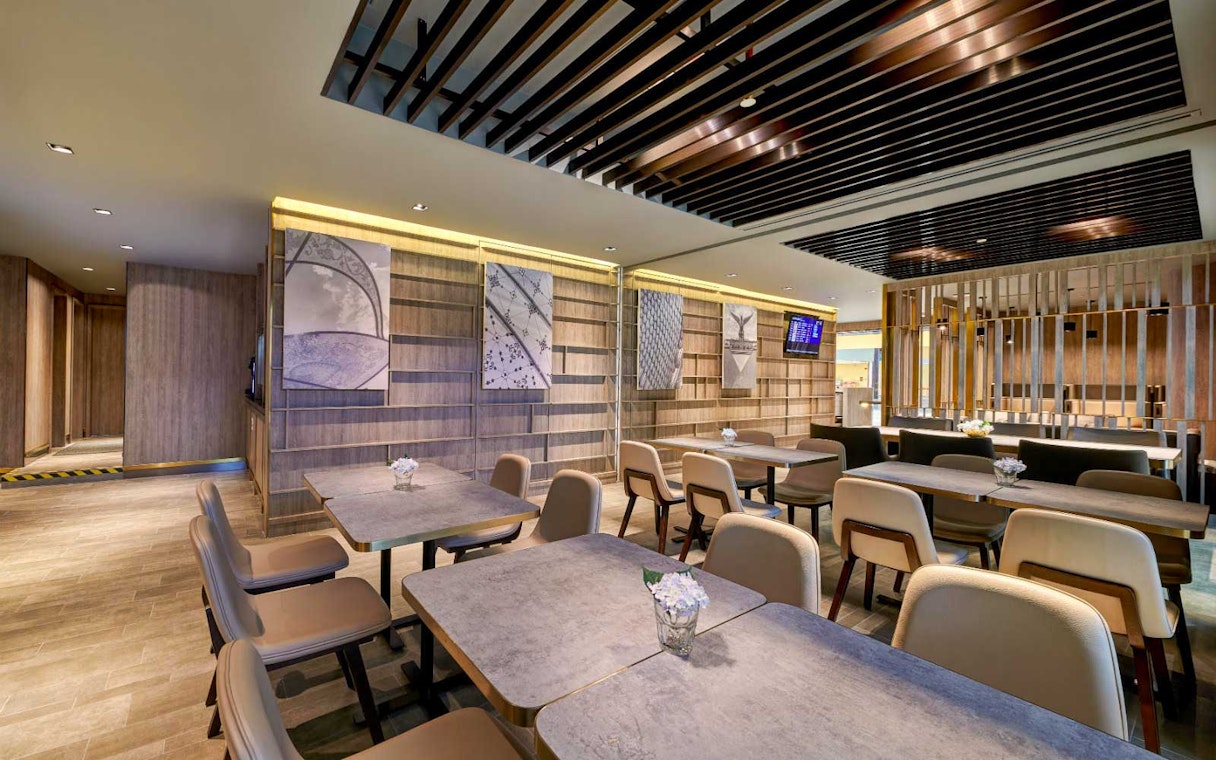 Plaza Premium Lounge seating area with modern decor and wall art.