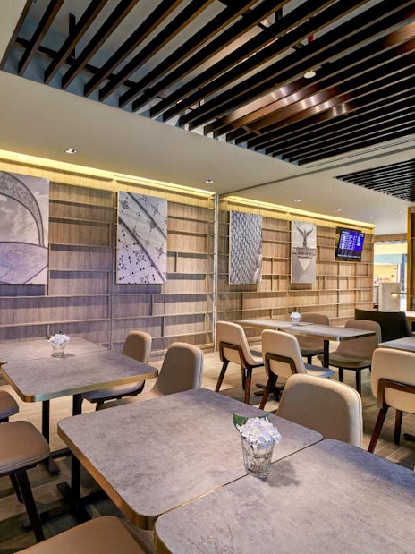 Plaza Premium Lounge seating area with modern decor and wall art.