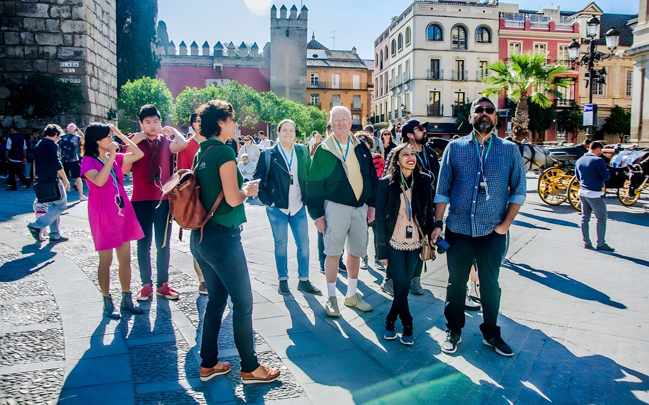 Group of tourists on a guided tour outside Alcazar in Seville.