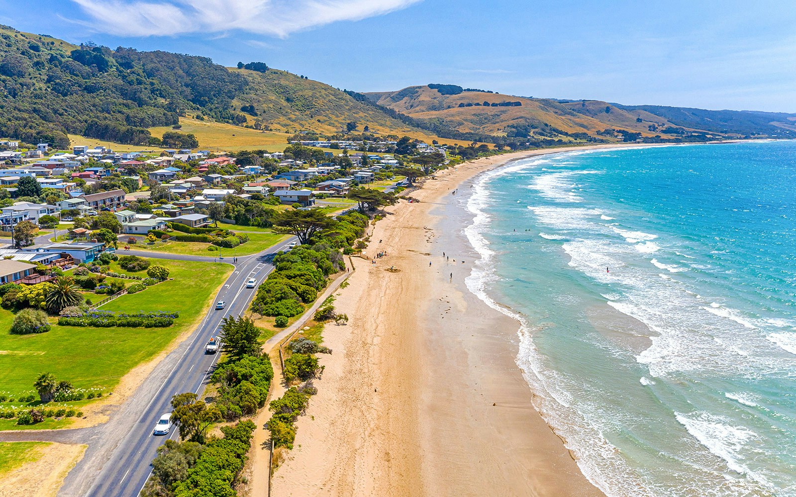 Coastal view of Apollo Bay with lush hills and ocean in Victoria, Australia.