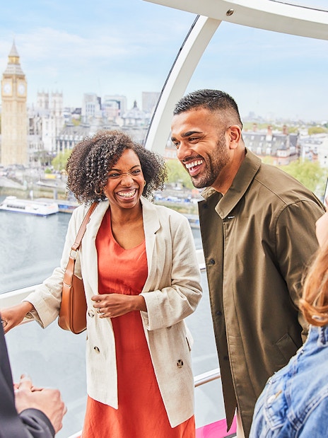 Group enjoying view inside the London Eye with Big Ben in the background.