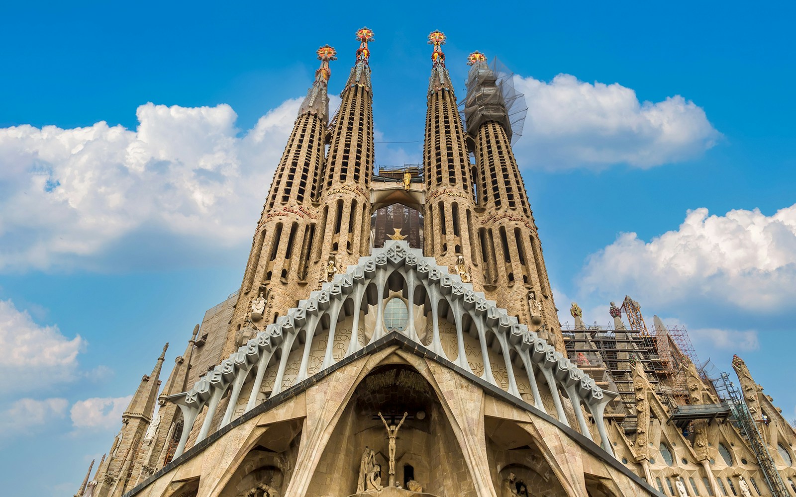 Sagrada Familia Cathedral facade with intricate spires in Barcelona, designed by Antonio Gaudi.