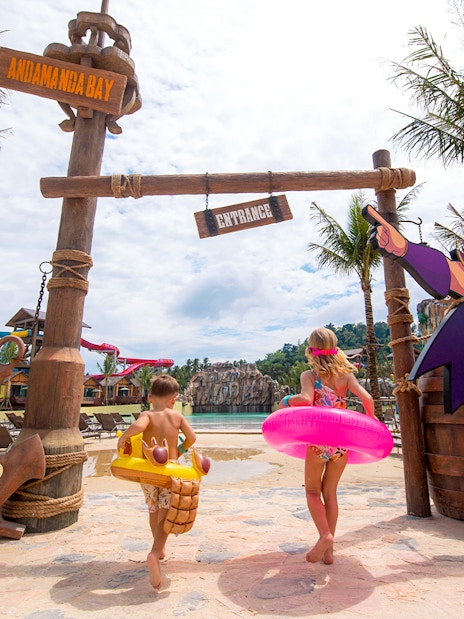 Children with floaties running towards a pool at Andamanda Bay, Phuket.
