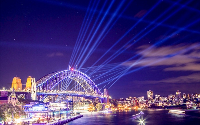 Sydney Harbour Bridge illuminated during Vivid Sydney Cruises.