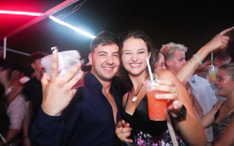 Guests enjoying drinks at Split night boat party with live DJ and free shots.