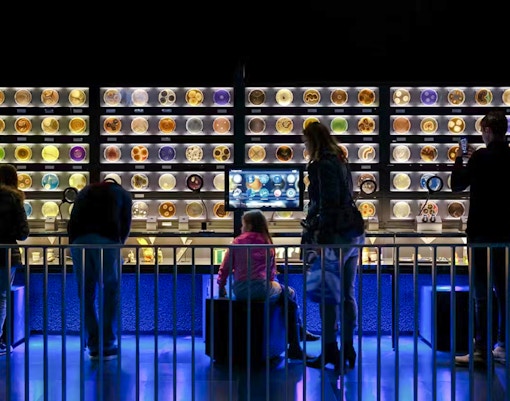 Visitors observing microbial displays at Artis Micropia in Amsterdam.