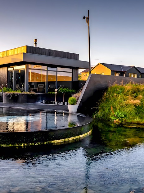 Krauma Geothermal Baths with modern architecture and natural surroundings in Iceland.