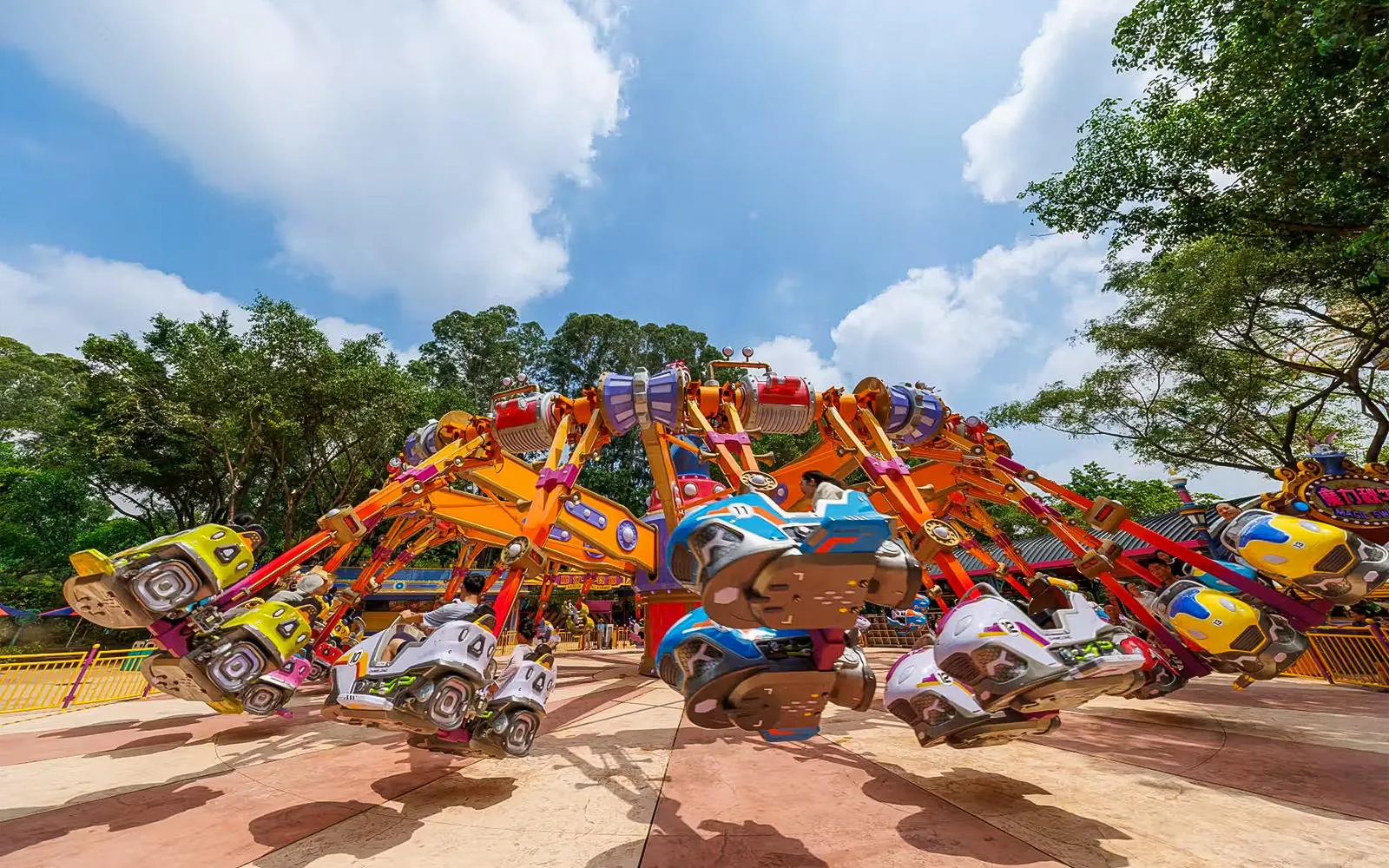 Colorful amusement ride at Chimelong Paradise with people enjoying the attraction.
