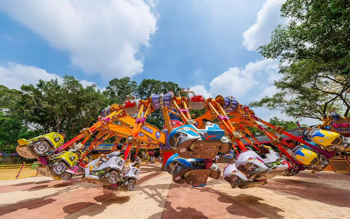 Colorful amusement ride at Chimelong Paradise with people enjoying the attraction.
