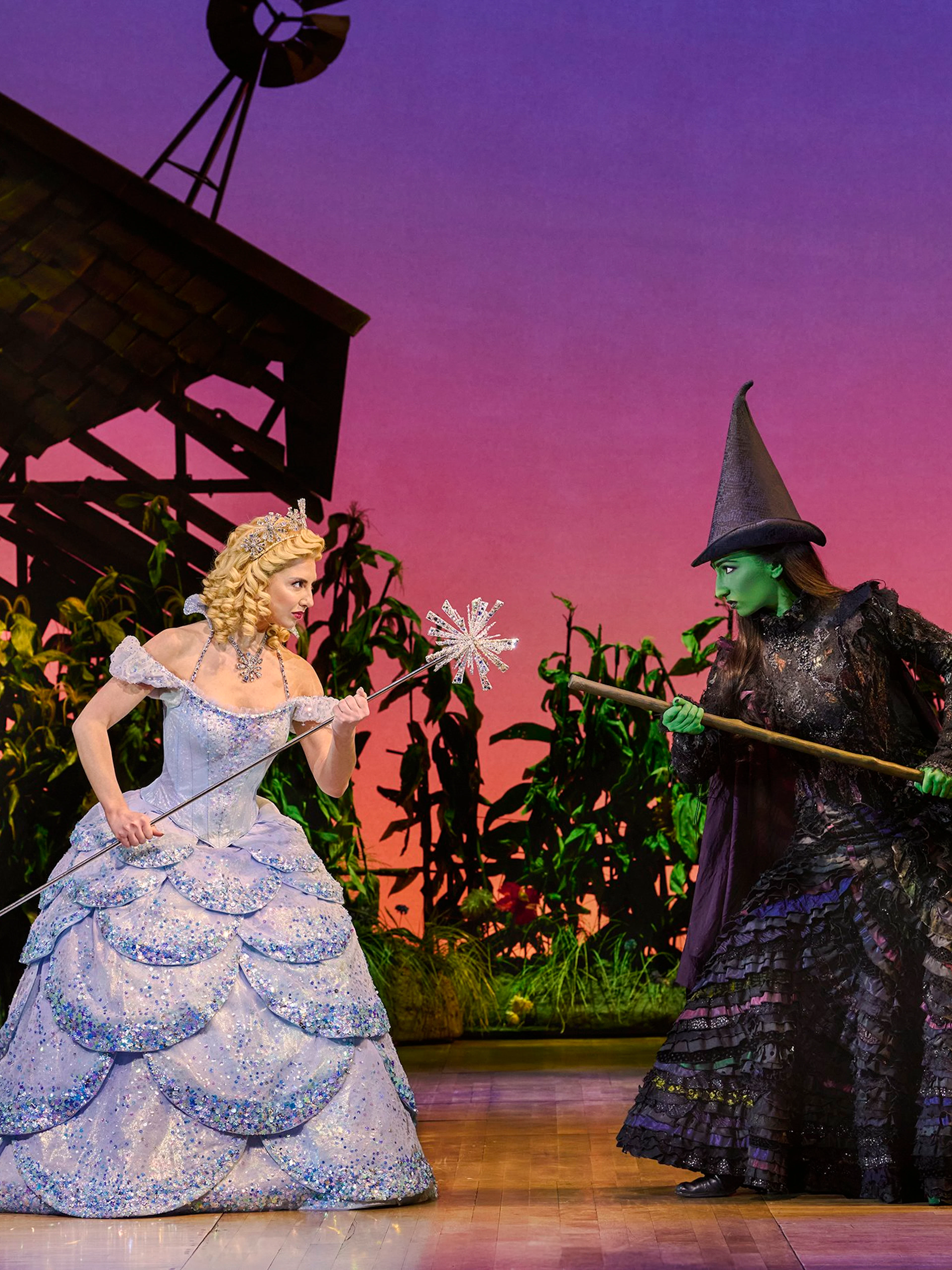 Two characters from Wicked musical in a dramatic scene on stage.