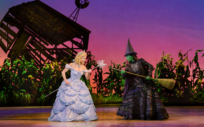 Two characters from Wicked musical in a dramatic scene on stage.
