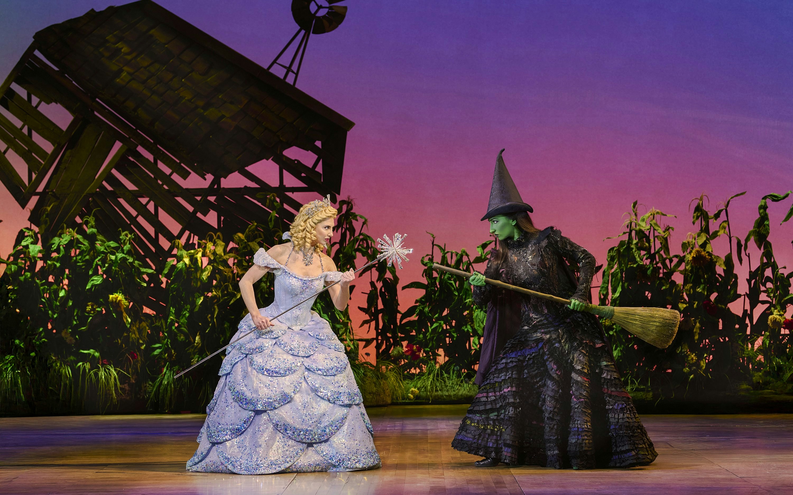 Two characters from Wicked musical in a dramatic scene on stage.