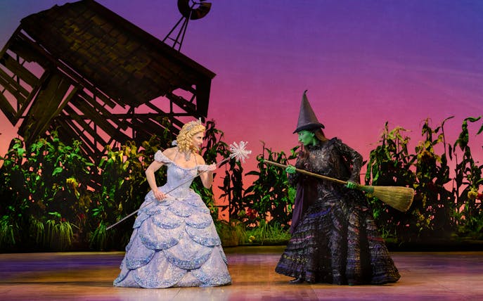 Two characters from Wicked musical in a dramatic scene on stage.