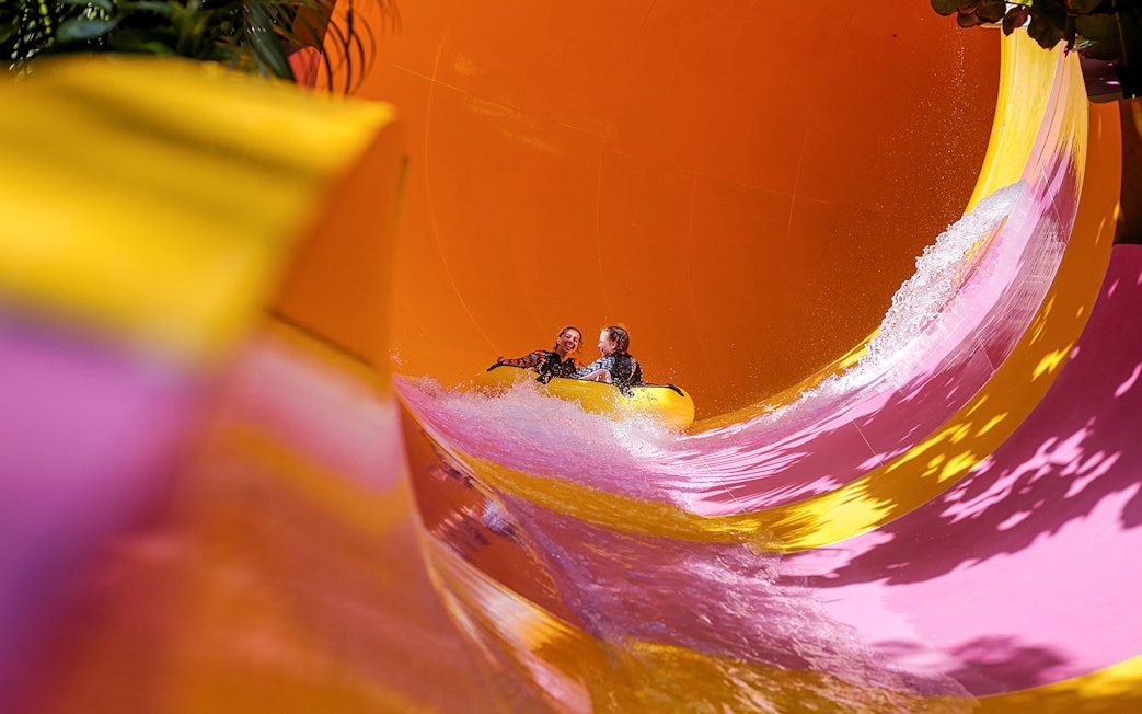 Two girls on a water tube sliding down the Python waterslide at Waterbom Bali.