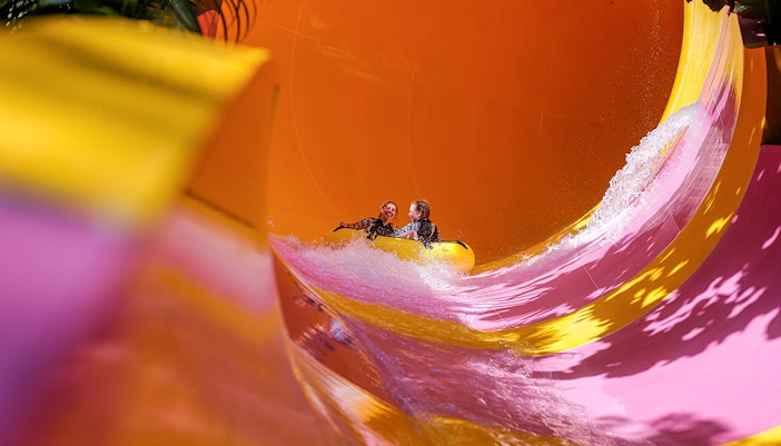 Two girls in a water tube coming down a the Python waterslide at Waterbom Bali water park