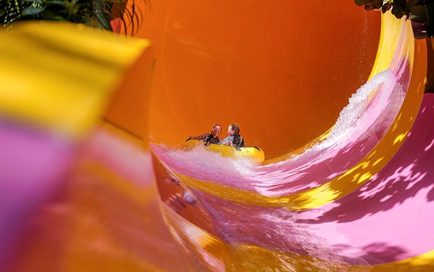 Two girls on a water tube sliding down the Python waterslide at Waterbom Bali.