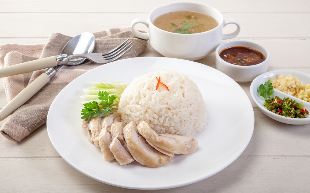 Hainanese chicken rice with soup and sauces, Singapore.