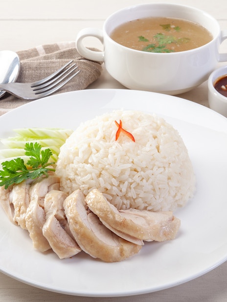 Hainanese chicken rice with soup and sauces, Singapore.
