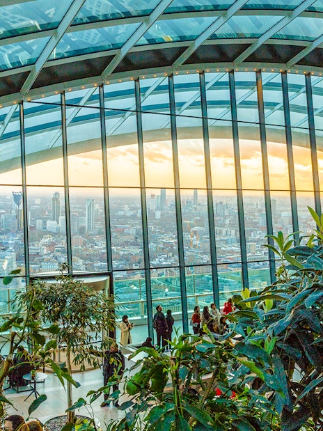 Visitors enjoying the view at Sky Garden, London with cityscape backdrop.