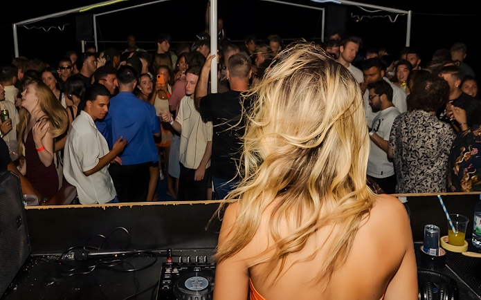 DJ performing on a crowded boat party in Split, Croatia.