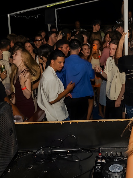 DJ performing on a crowded boat party in Split, Croatia.