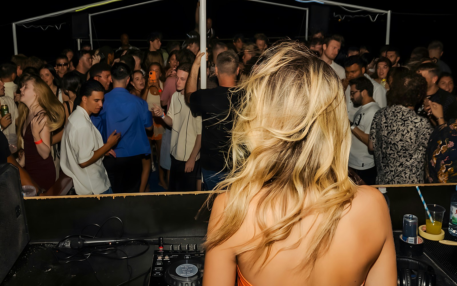 DJ performing on a crowded boat party in Split, Croatia.