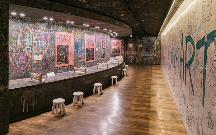 Interactive art wall and seating area at Teddy Bear Museum.