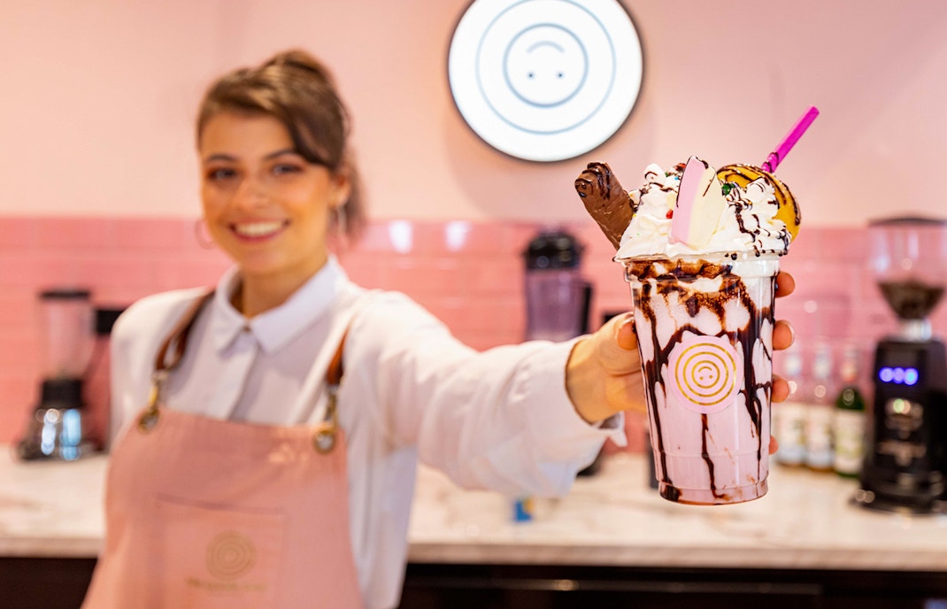 Milkshake with whipped cream and chocolate drizzle at Cafe