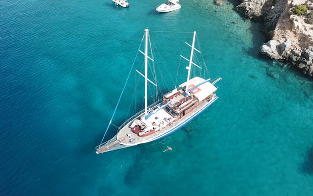 Sailing boat on clear blue waters during Half Day Athens Cruise with swim stop.