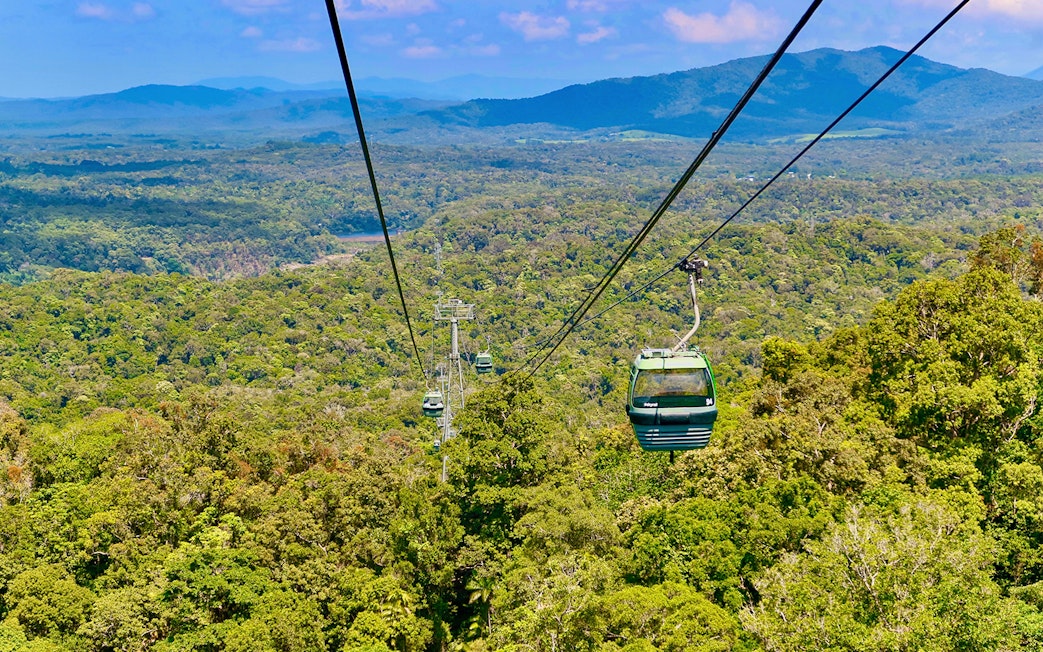 Kuranda Skyrail Rainforest Cableway gliding over lush forest canopy in Queensland, Australia.