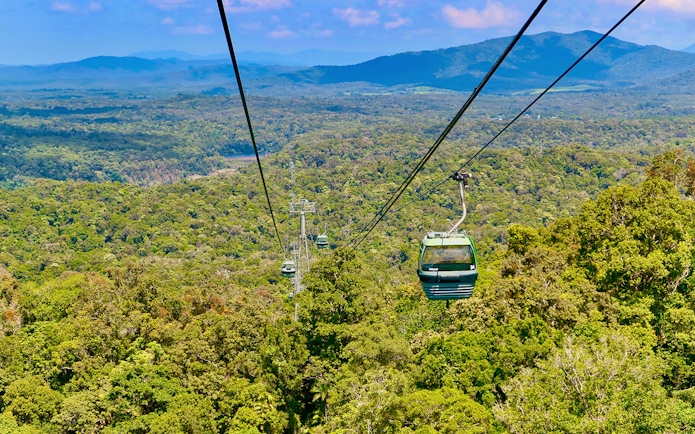 Kuranda Skyrail Rainforest Cableway gliding over lush forest canopy in Queensland, Australia.